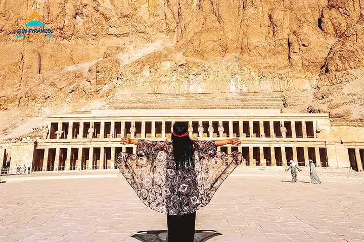 Woman facing Hatshepsut Temple in Luxor, highlight of Luxury 8 days Cairo itinerary and Oberoi Philae Nile Cruise