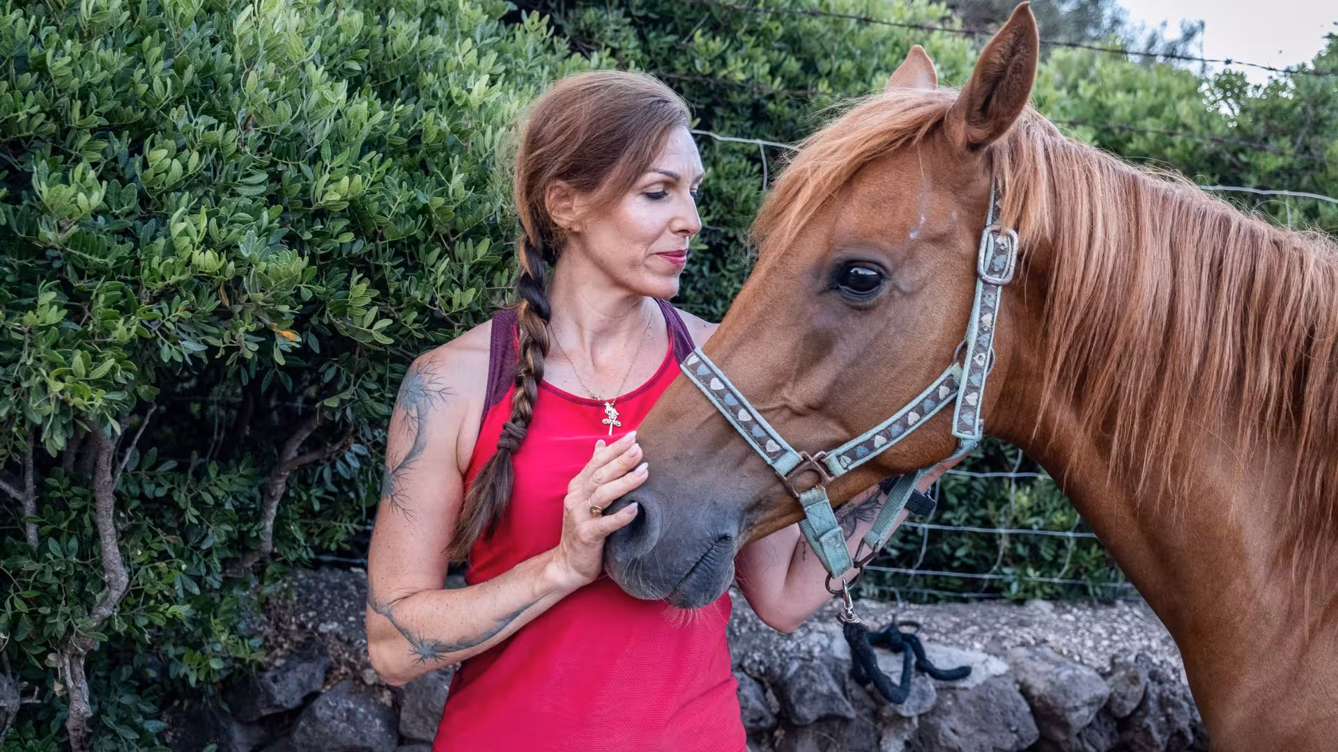 Woman bonding with horse during Dorgali panoramic horseback tour, showcasing connection and natural beauty.