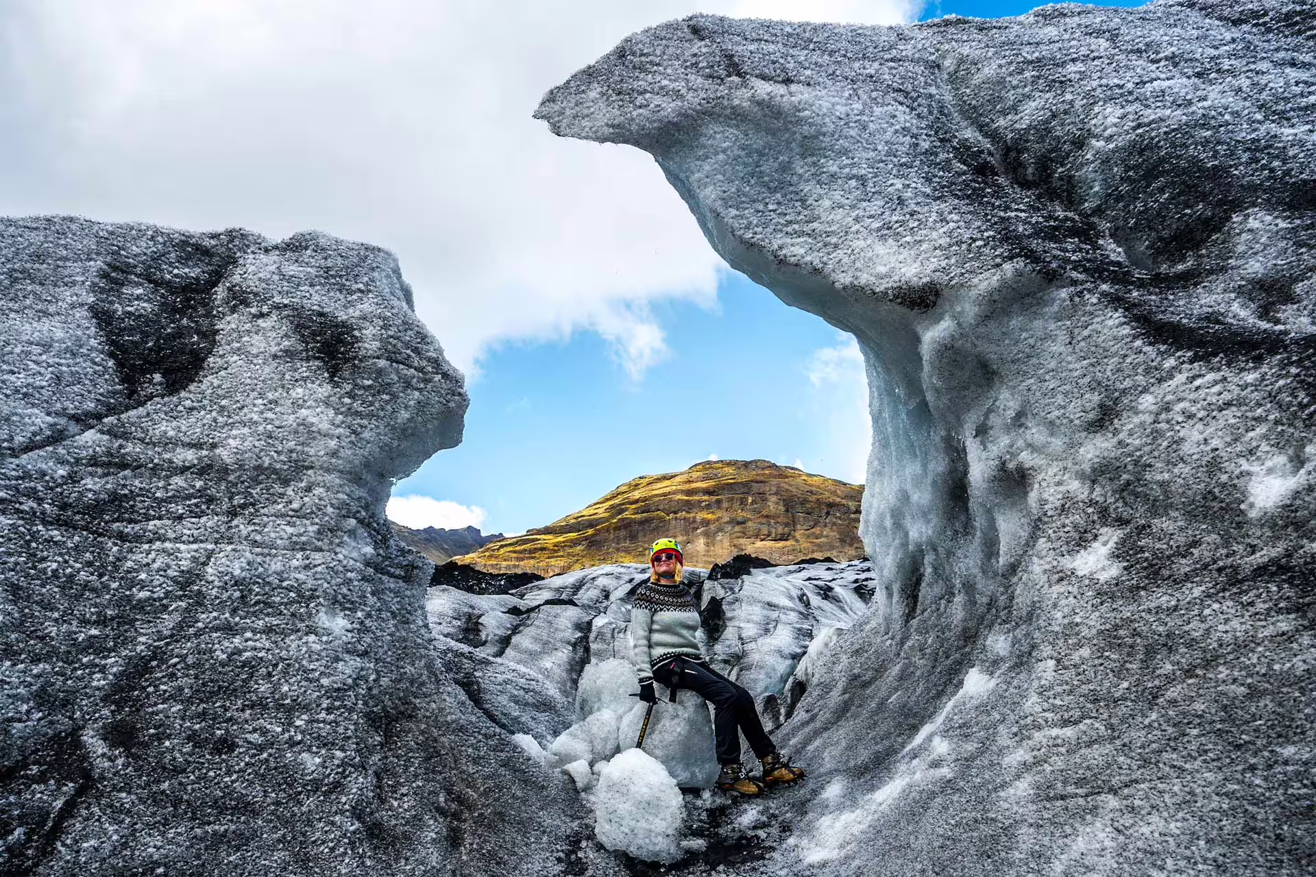 Woman sitting around icicle skulptures.