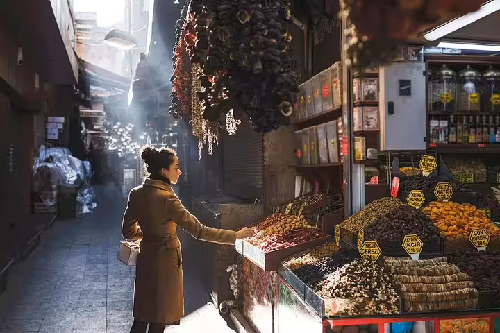 Woman browsing spice and dried fruit stall in Istanbul market, personal travel photographer tour street photos