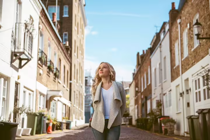 Woman strolling down a charming London street, perfect for a personal travel photography session.