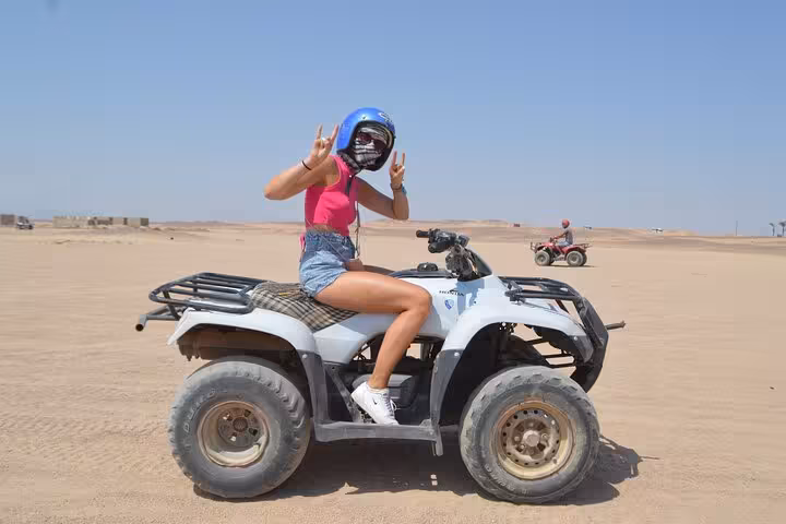 Woman on quad bike in Sharm El Sheikh desert dunes during mega safari waves and dunes adventure with lunch