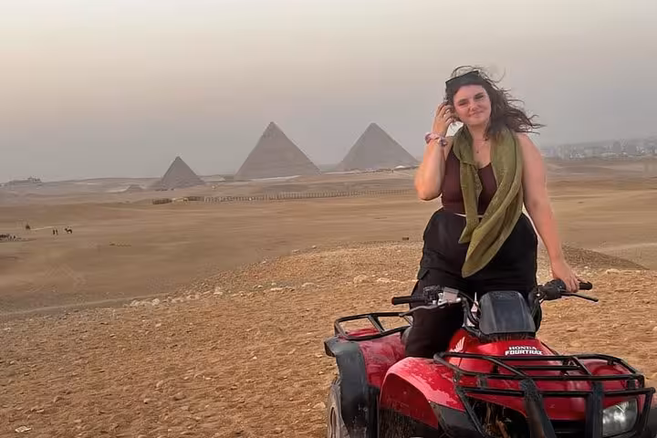 Woman on red ATV with Giza Pyramids in background, Cairo desert quad biking on felucca sail and Khan El Khalili tour