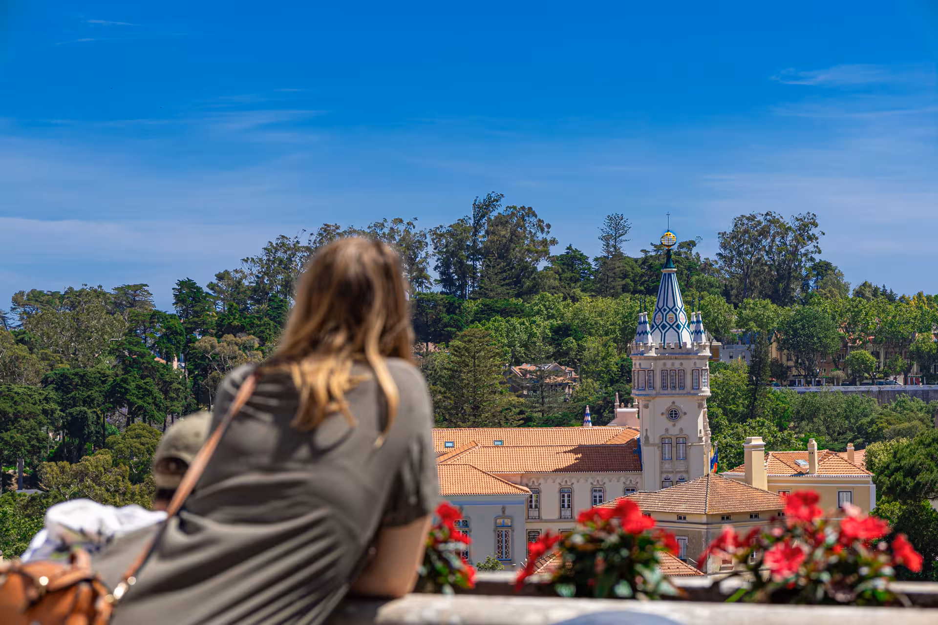 Woman enjoying scenic view of Sintra's historic architecture on Lisbon small group tour.