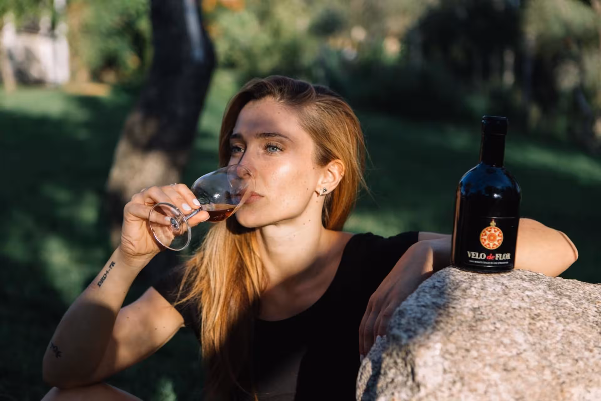 Woman enjoying wine tasting in Gallura vineyard, showcasing Sardinian winery tour experience.