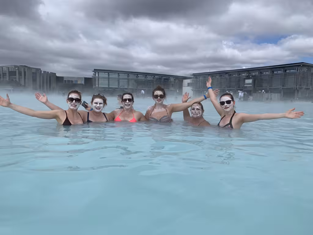 Women enjoying rejuvenating soak in Iceland's Blue Lagoon with silica mud masks on a summer adventure tour.
