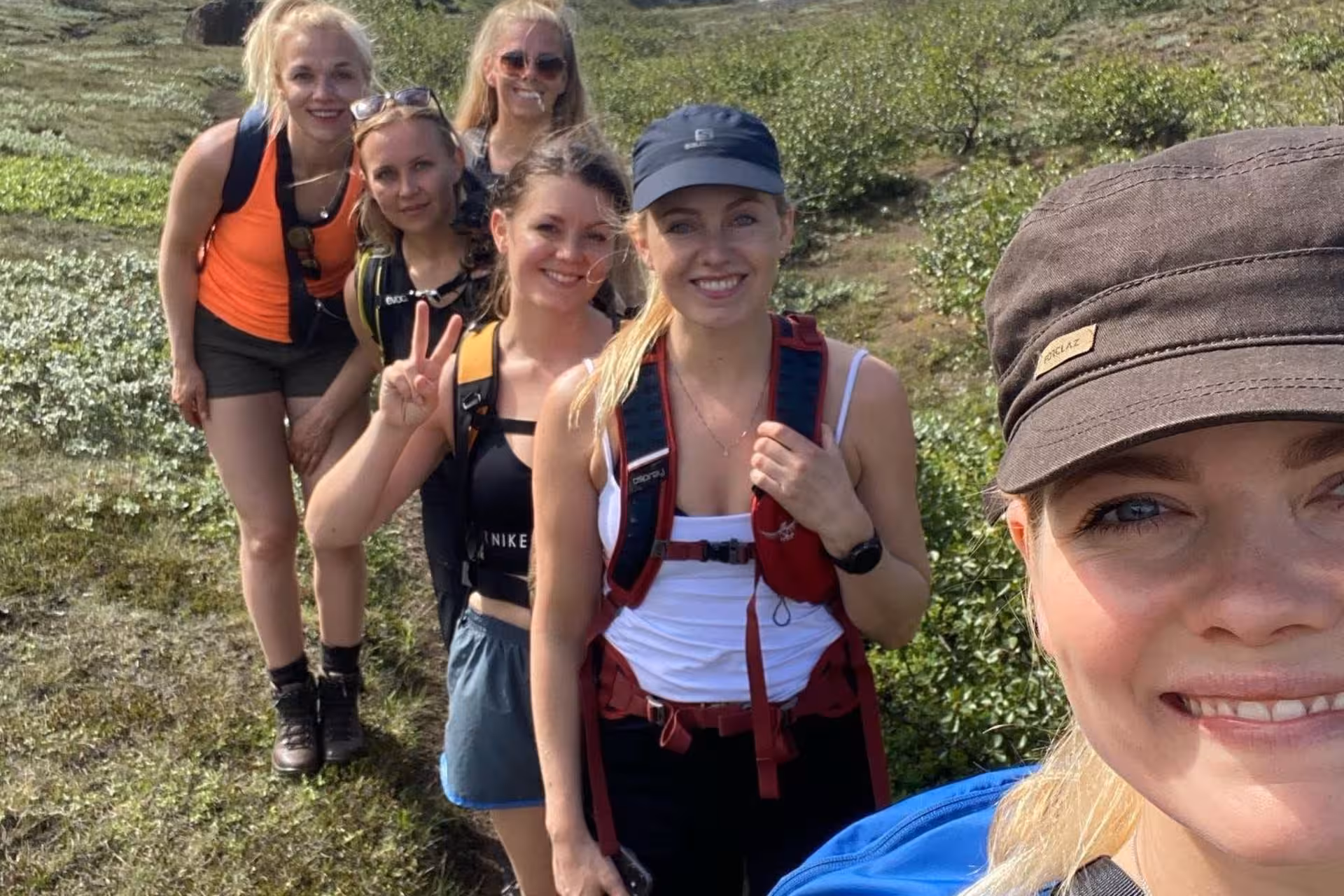 Group of women hikers smiling on Fimmvorduhals trail in Iceland on a sunny day