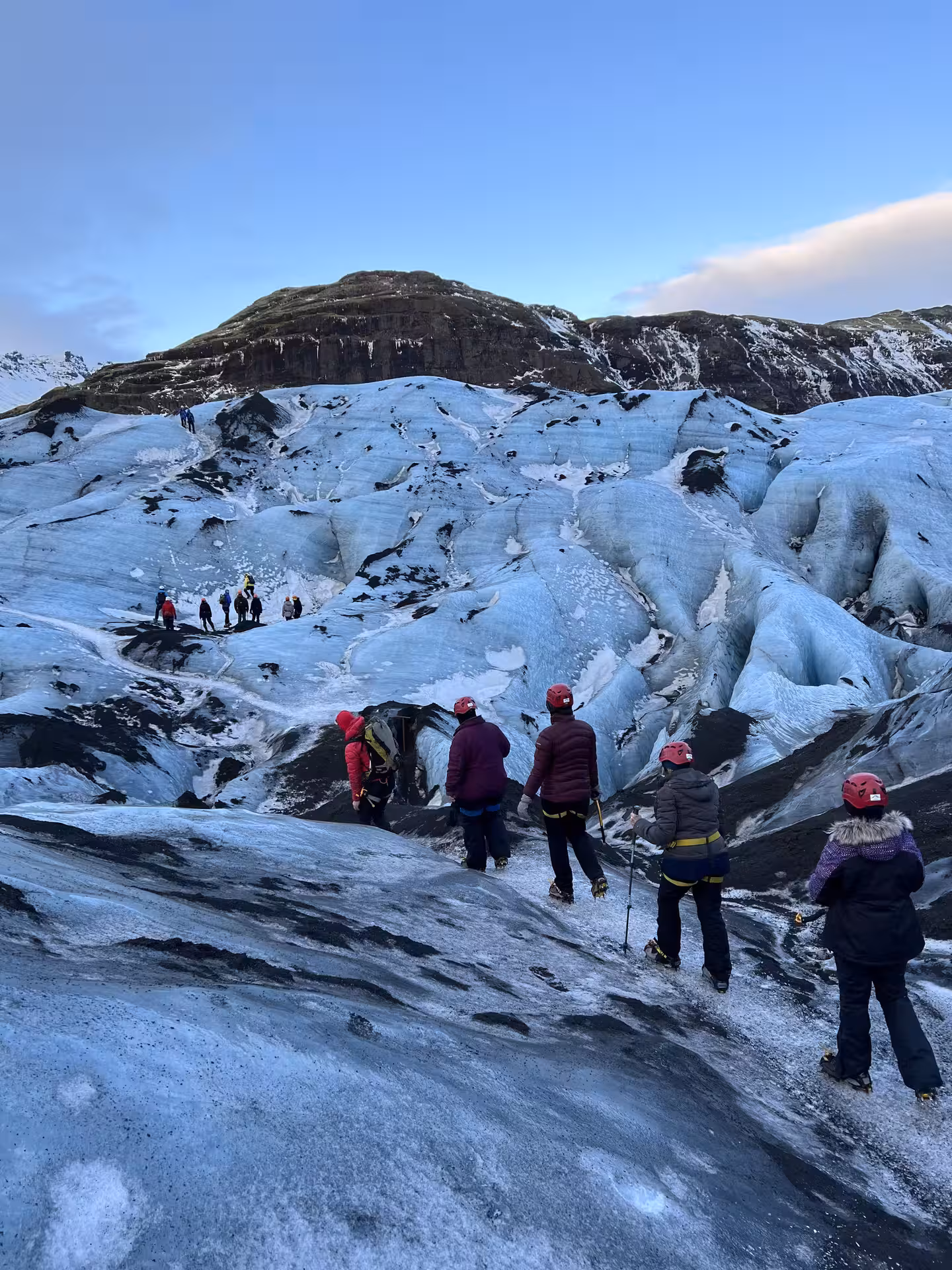 Women adventurers exploring Iceland's stunning glacier landscape, experiencing thrilling ice climbing on a women's-only tour.