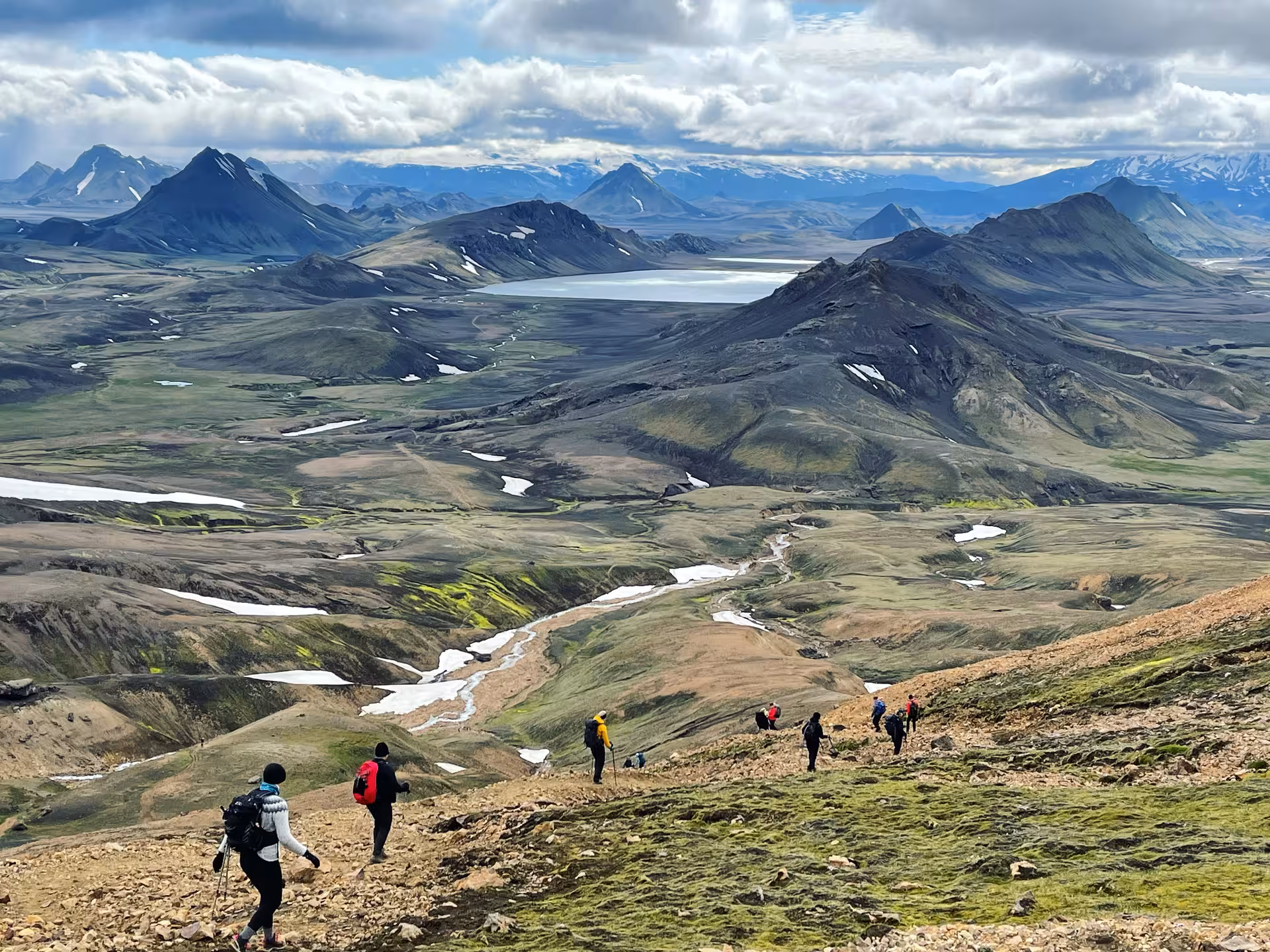 Group of women hiking along the scenic Laugavegur trail with panoramic views of Iceland's rugged mountains and valleys.
