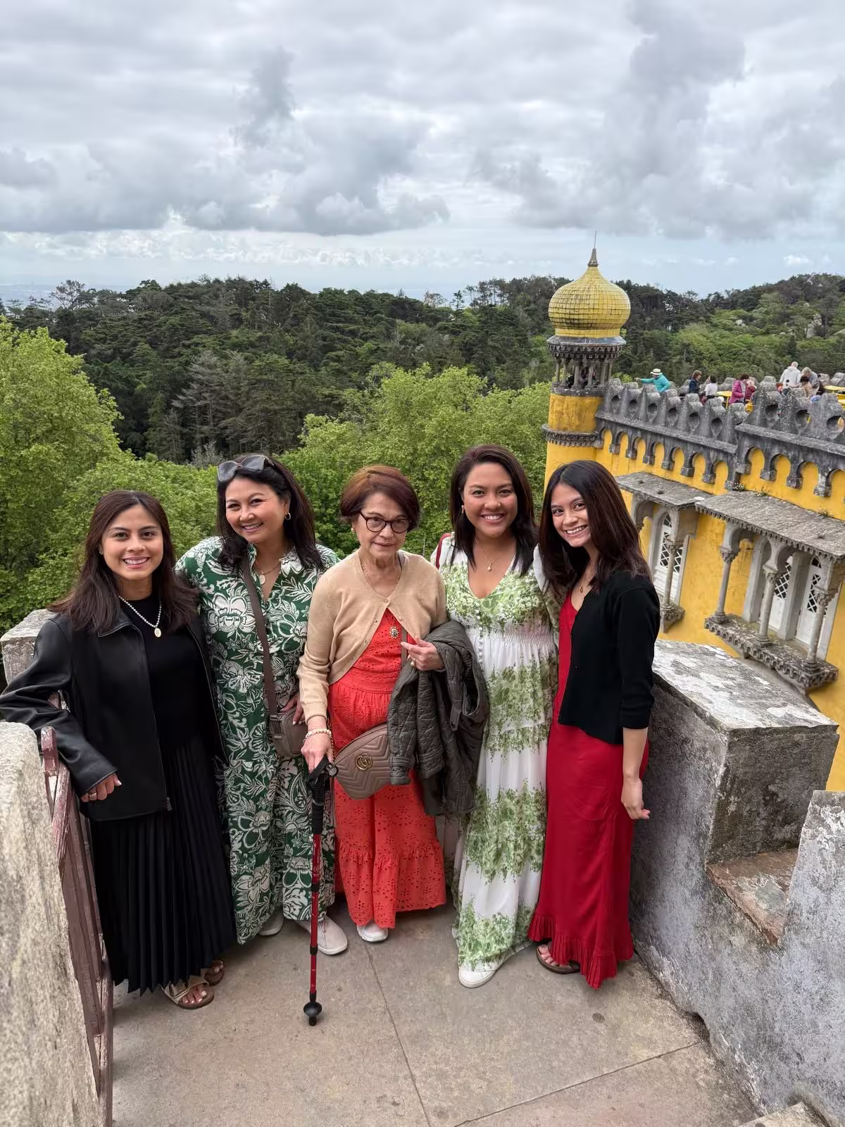 Group of women enjoying a day at the vibrant Pena Palace in Sintra, surrounded by lush greenery and historic architecture.