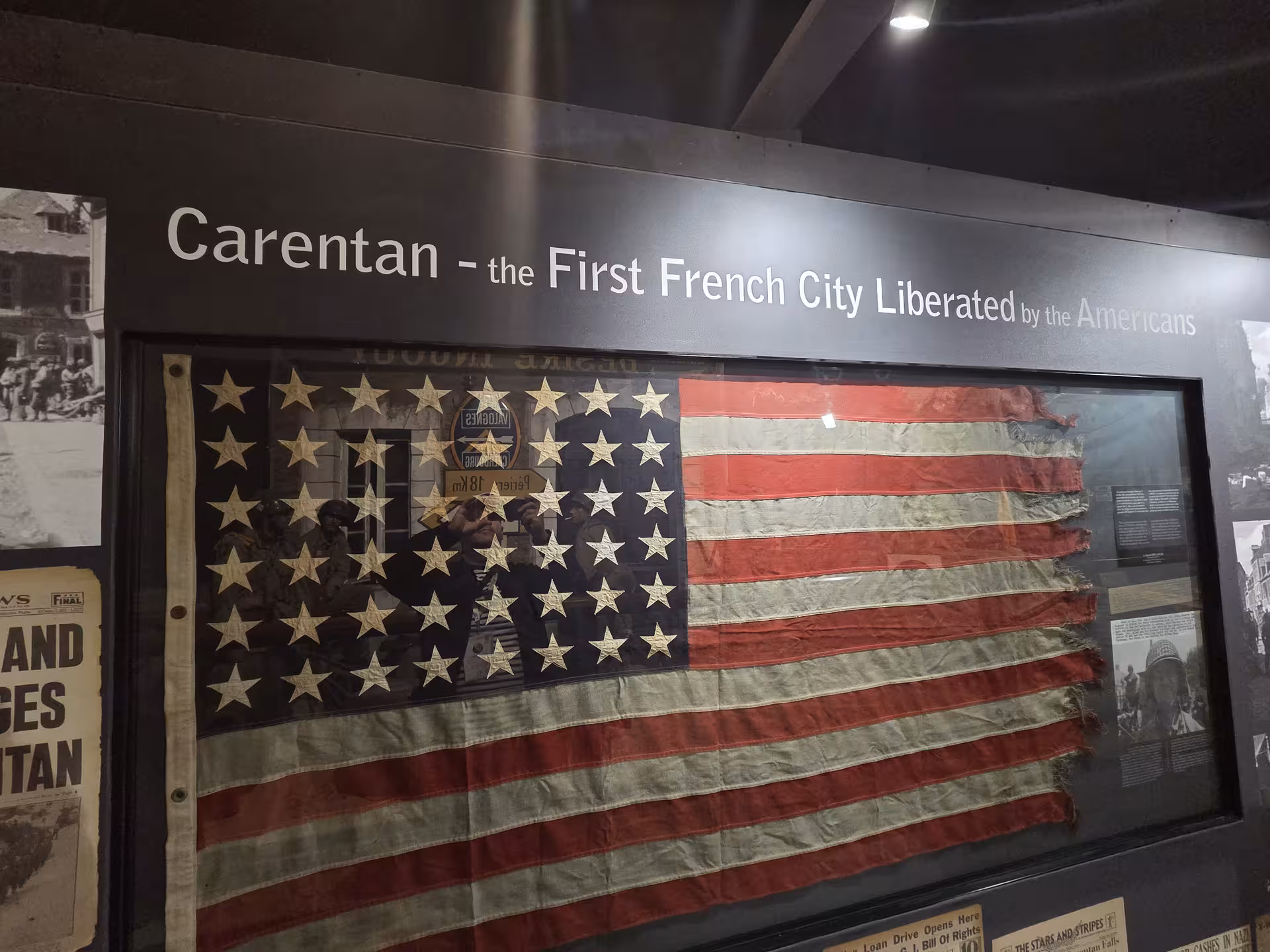 Historic WWII American flag displayed at Carentan museum exhibit on Normandy D-Day guided tour