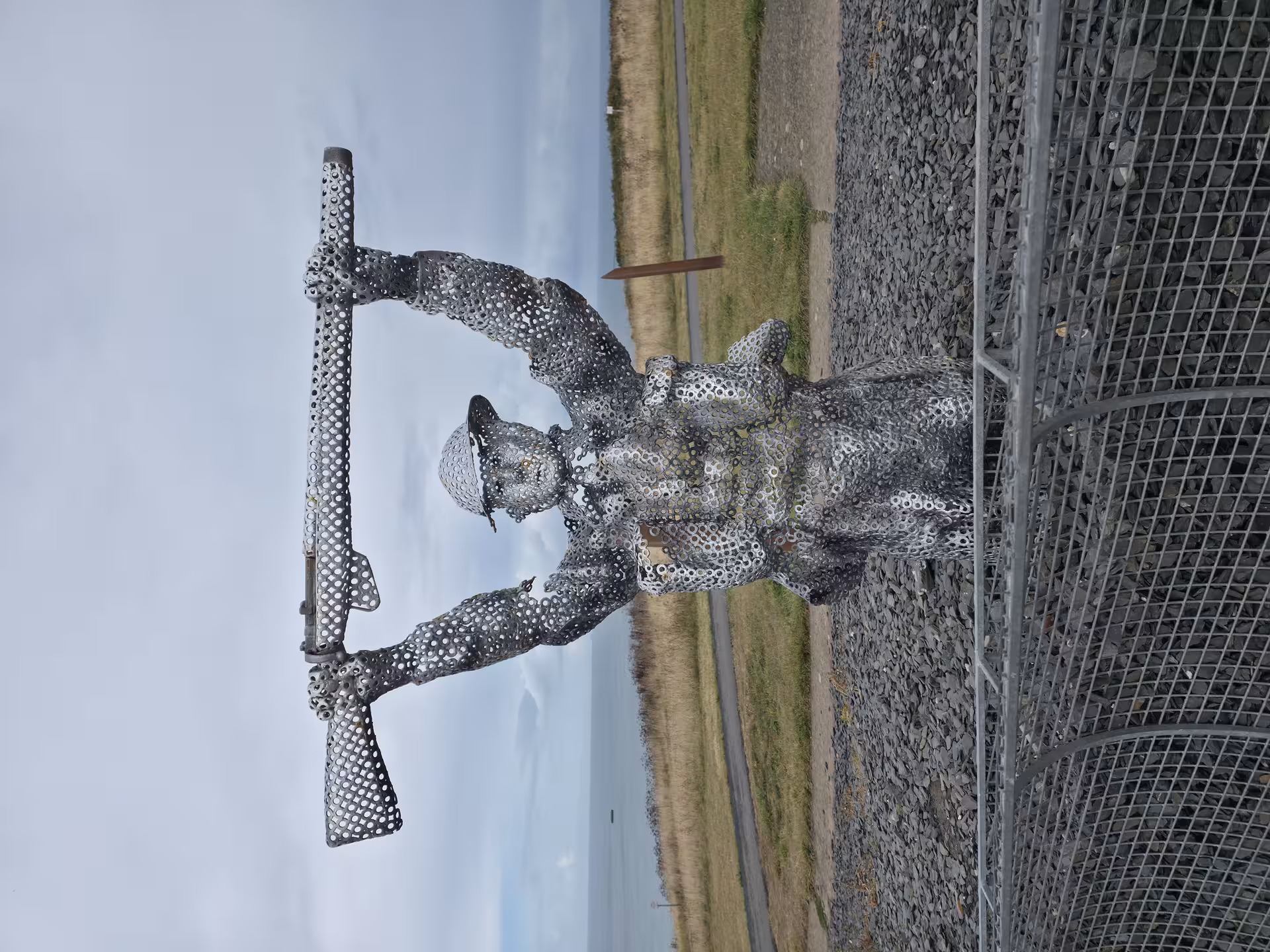 Steel WWII soldier sculpture at Normandy D-Day beach site on a private guided history tour