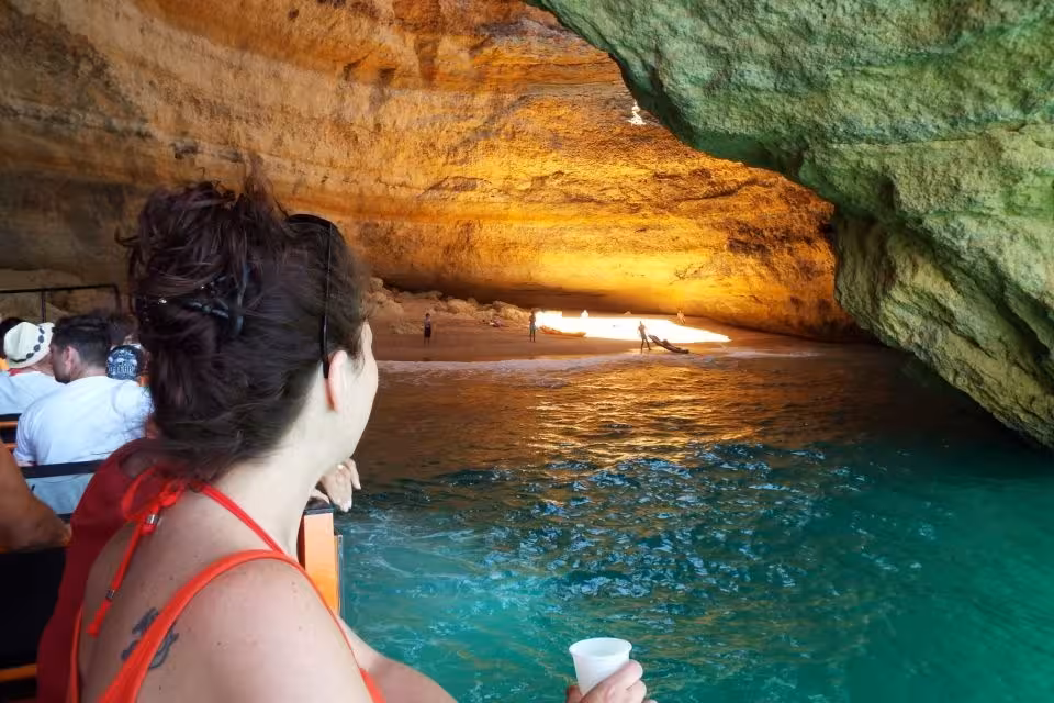 Guests on X Ride boat cruise into the glowing Benagil sea cave, admiring turquoise water and hidden Algarve beach