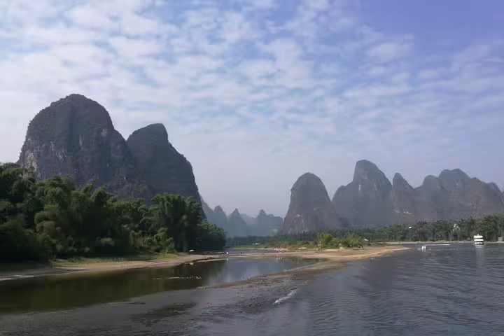 Breathtaking Yangshuo landscape with iconic karst mountains and riverbank, perfect for a relaxing day tour.