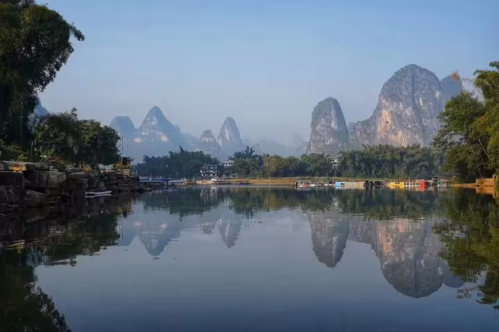 Tranquil Li River with karst mountain reflections in Yangshuo, highlighting a picturesque private day tour experience.