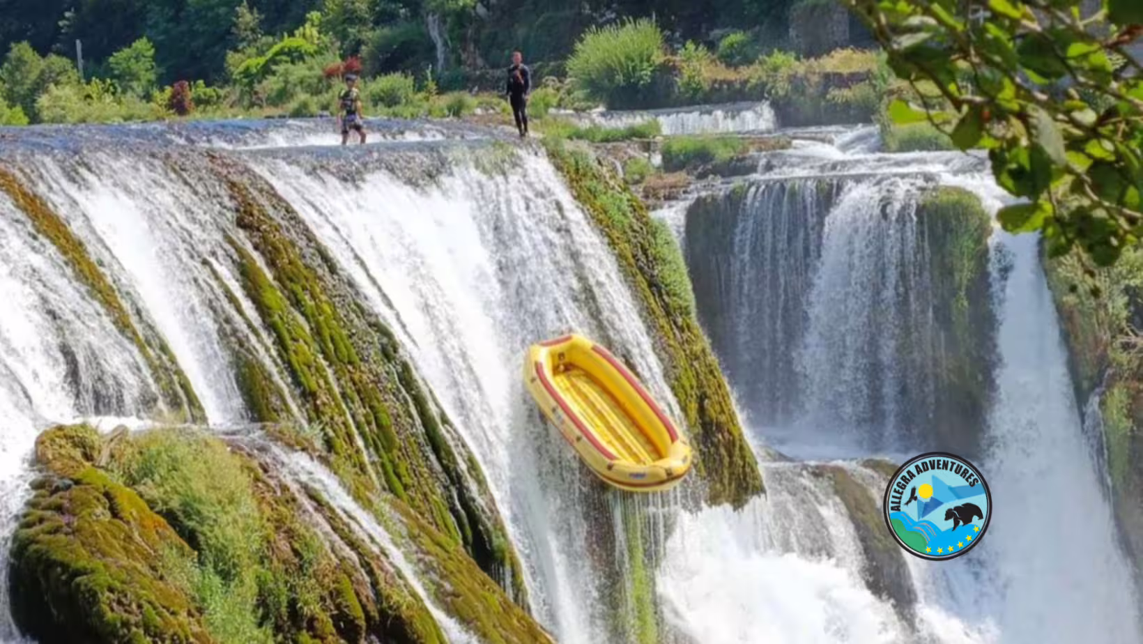 Yellow raft beside cascading waterfalls on the Una River, adventure rafting day trip from Plitvice Lakes National Park