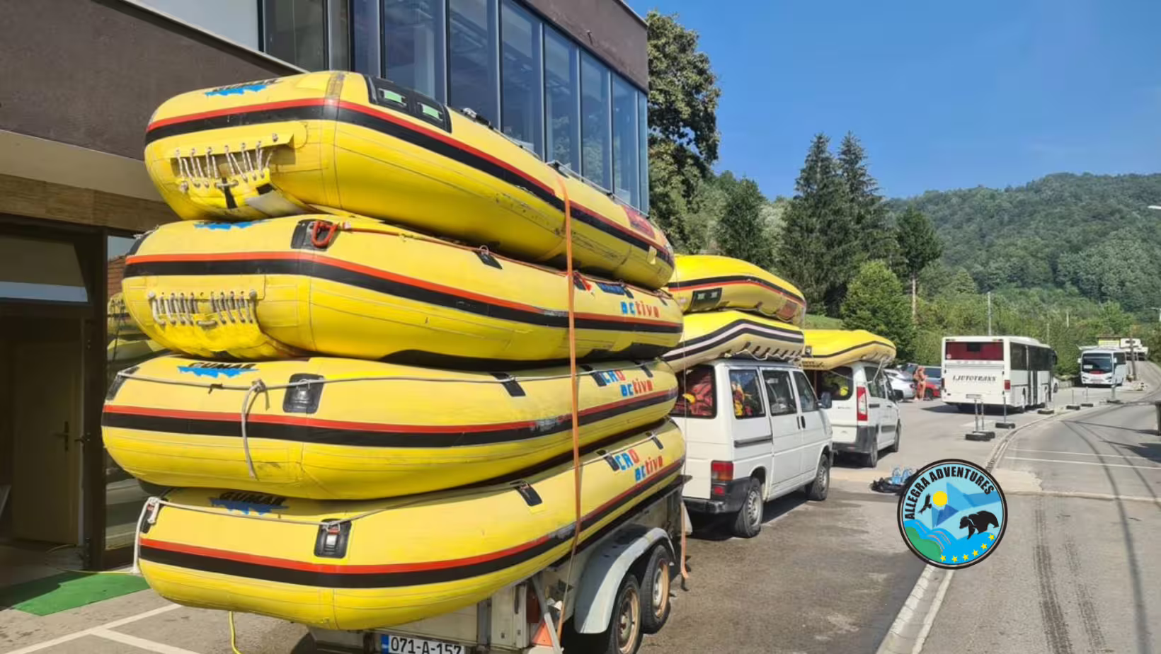 Stacked yellow rafts loaded on trailer for Una River rafting tour pickup, transfer from Plitvice Lakes National Park