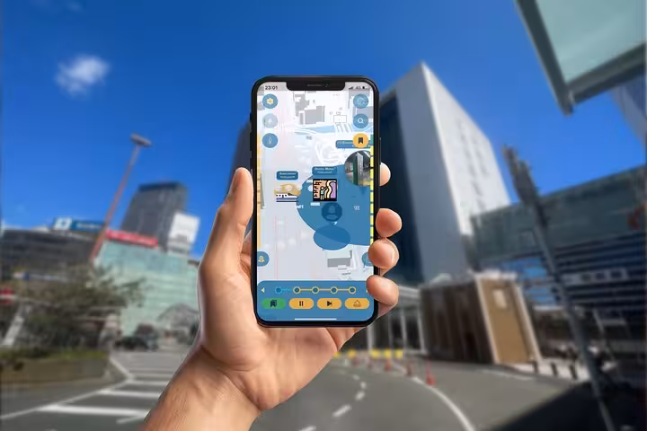 Hand holding smartphone with GPS walking tour app map in Yokohama city street
