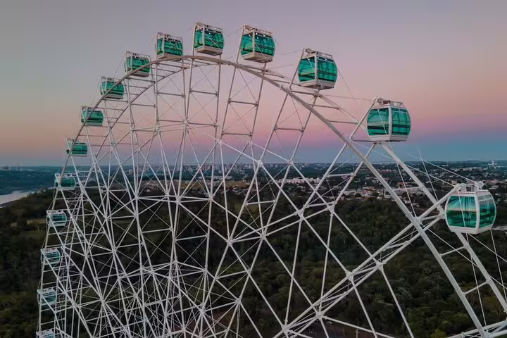 Panoramic view of the Yup Star Ferris Wheel at dusk, offering stunning vistas over lush landscapes and cityscape.