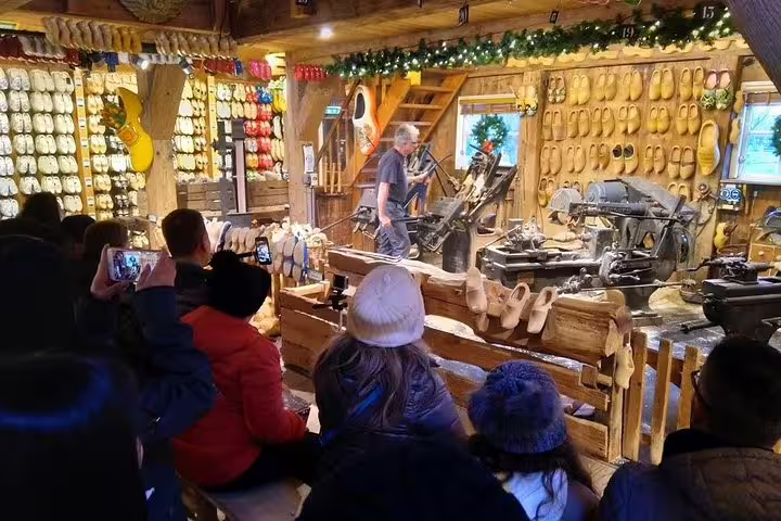 Visitors watch a clog-making demonstration at Zaanse Schans on a small-group half-day tour from Amsterdam