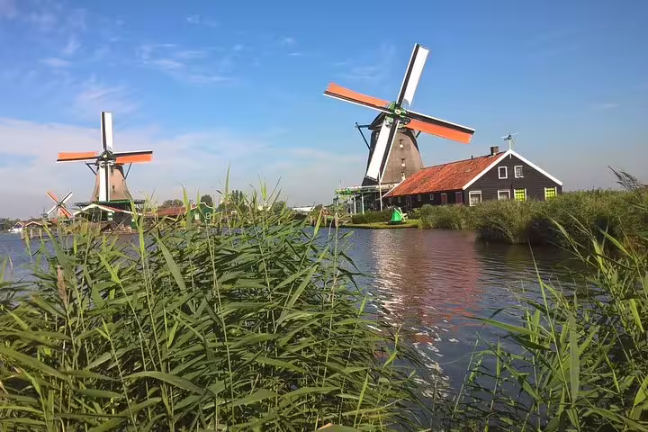 Zaanse Schans windmills by the canal near Amsterdam, classic Dutch village view on a small-group half-day tour
