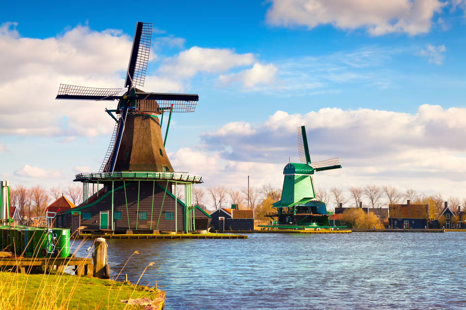 Zaanse Schans windmills by the river on a 1-day walking tour with multilingual audioguide in Holland