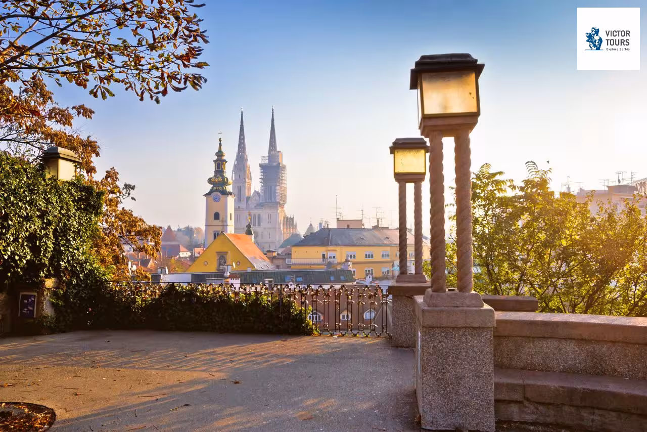 View of Zagreb Cathedral with autumn foliage and traditional architecture in the background, Croatia.