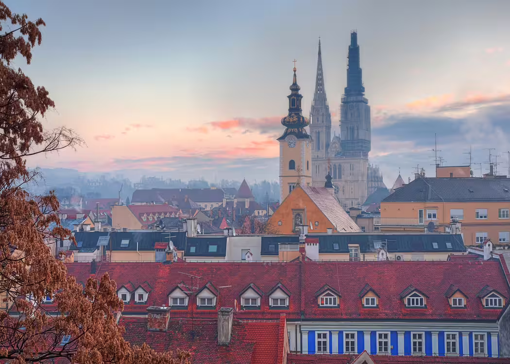 Zagreb city break private tour featuring Zagreb Cathedral skyline and red rooftops at sunset in Croatia