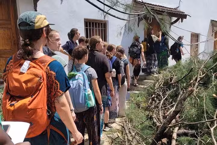 Tourists line up outside a traditional building in Zanzibar, eager to explore the island's cultural heritage.