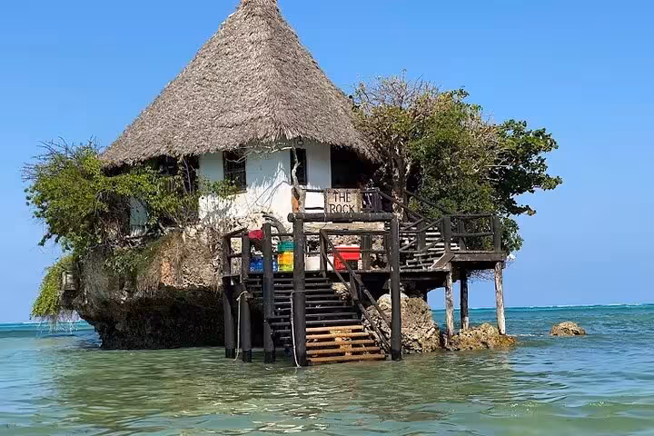 Discover the iconic Rock Restaurant perched on a rock in the Indian Ocean, a must-see on your Zanzibar half-day tour.