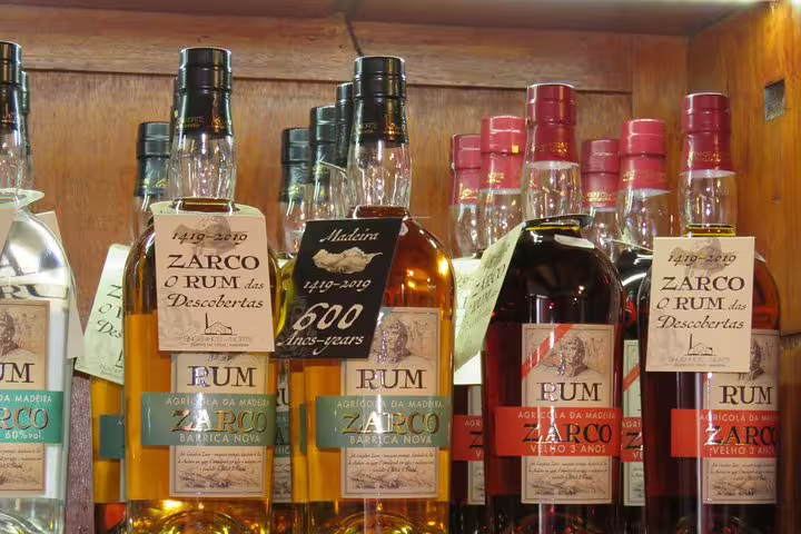Bottles of Zarco rum on display, highlighting Madeira's rich heritage, featured in the Santana & Peaks 4x4 tour.