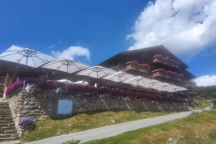 Mountain chalet restaurant stop on Zurich to Aletsch Glacier day trip, sunny terrace with alpine views