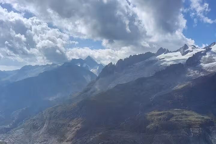 Swiss Alps panorama on Zurich day trip, with Aletsch Glacier peaks under dramatic clouds in Valais