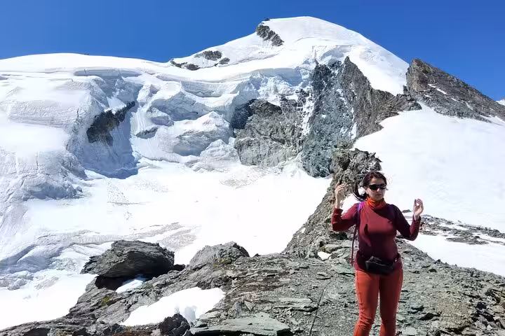 Traveler on snowy Allalin glacier viewpoint near Mittelallalin, highlight of Zurich day trip with revolving restaurant