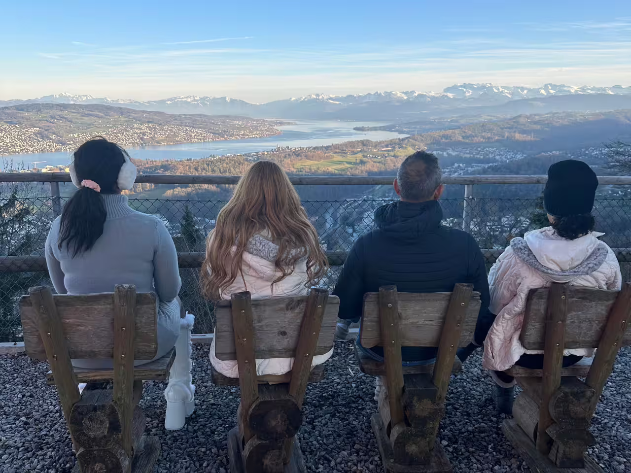 Group enjoying stunning Zurich lake and mountain view from a lookout point.