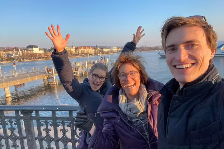 Friends selfie on Zurich lakeside promenade during a self-guided scavenger hunt and sights walking tour