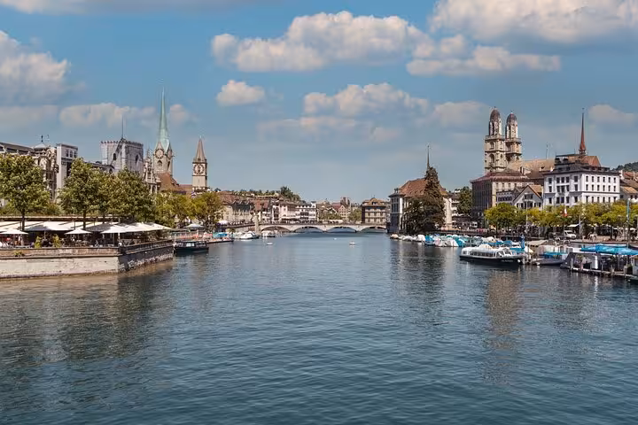 Limmat River view with Grossmünster and Old Town, highlight of Zurich 360 city walk tour hidden spots