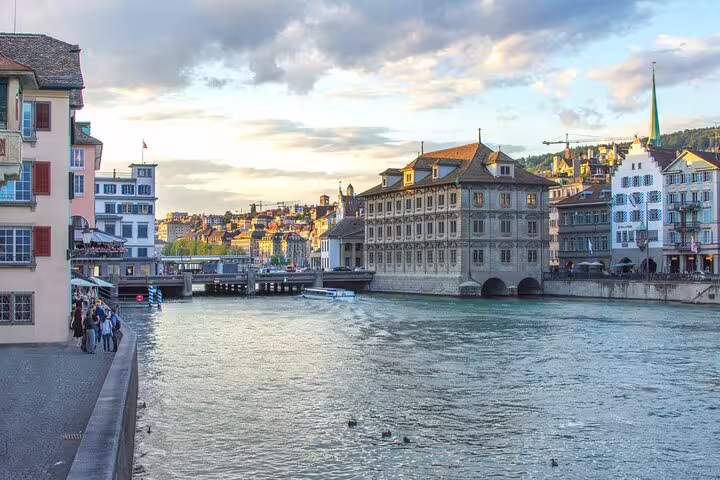Zurich old town waterfront along the Limmat River with historic buildings at sunset