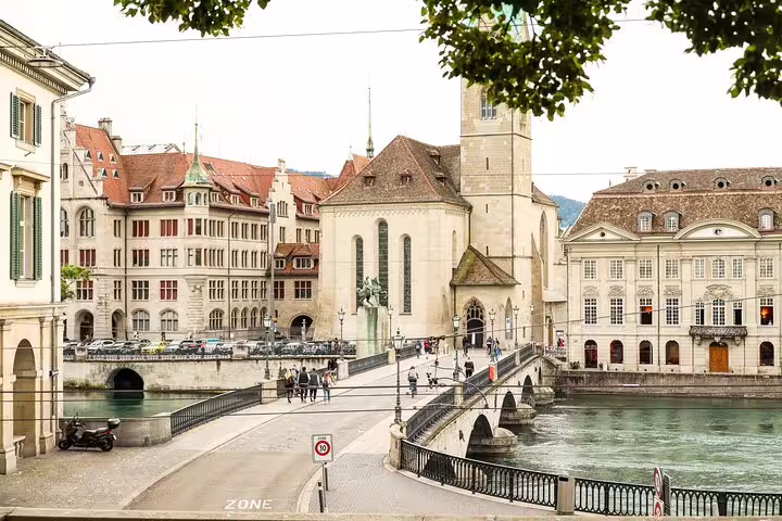 Historic Zurich old town with Münsterbrücke bridge over Limmat River and Grossmünster church tower