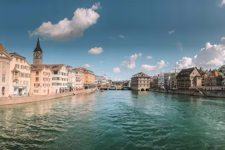 Scenic view of Zurich old town along the Limmat River with historic buildings and church steeple