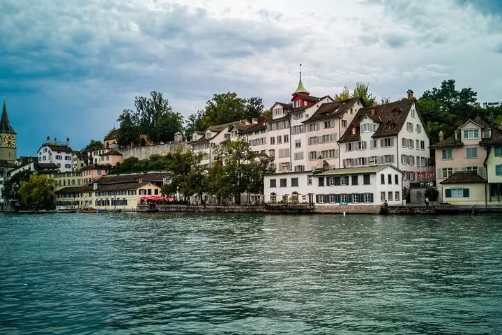 Zurich old town waterfront buildings along the Limmat River with historic architecture and church tower