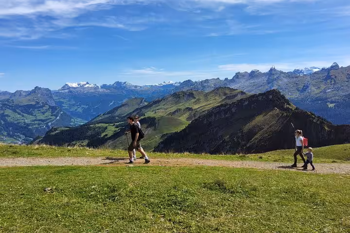 Hikers on Mount Rigi trail with sweeping Swiss Alps views on a Zurich day trip to Rigi and funicular ride