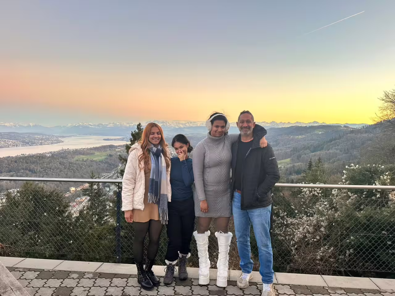 Group enjoying panoramic views of Zurich and the Alps at sunset during a private half-day tour with cable car ride.