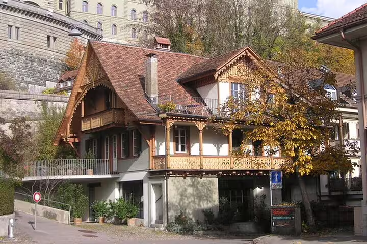 Traditional Swiss chalet-style house with ornate wooden balconies and terracotta roof in Zurich old town