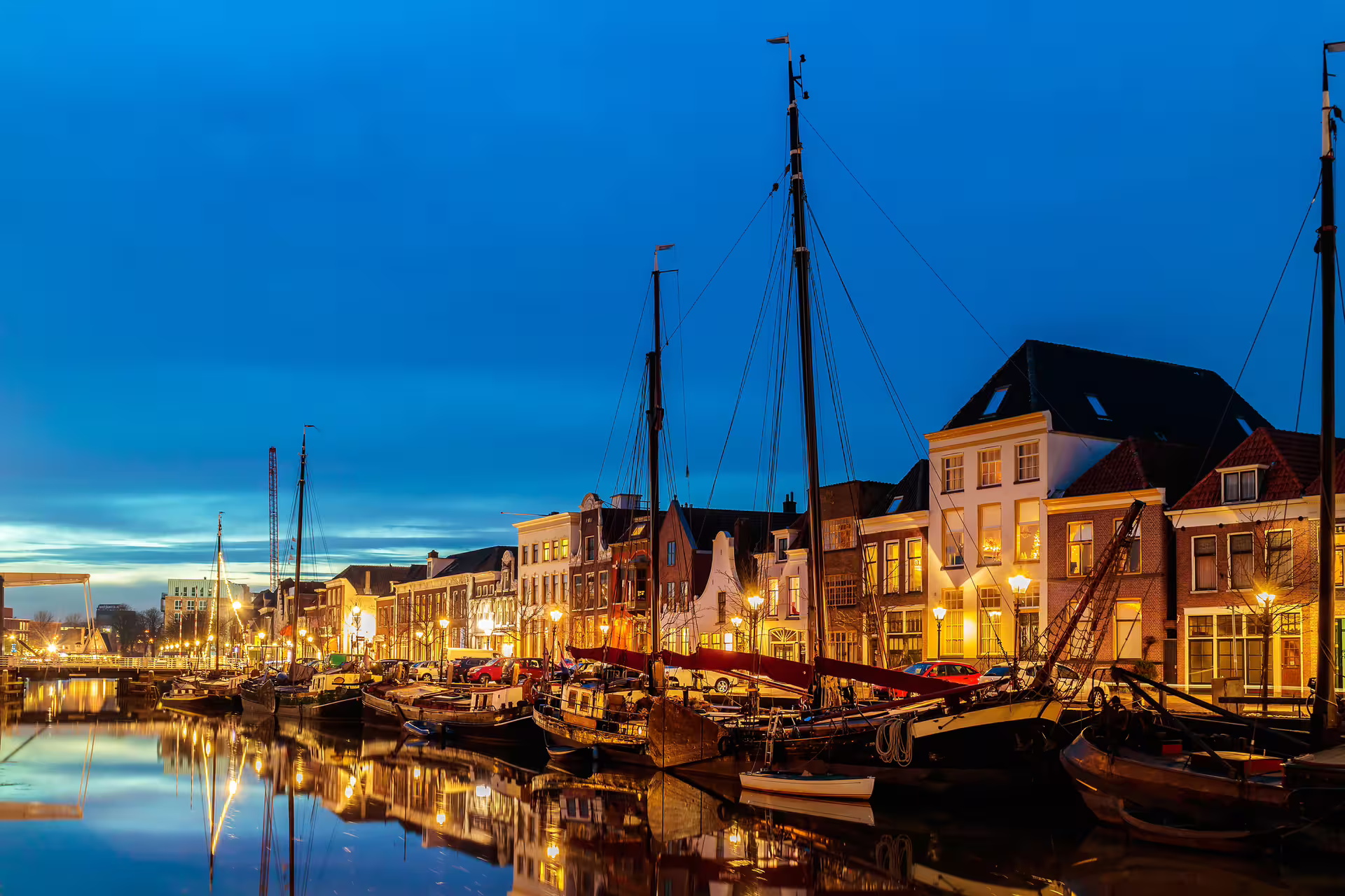 Evening harbor in Zwolle with sailboats and waterfront lights, highlight of 1-day walking tour with audioguide