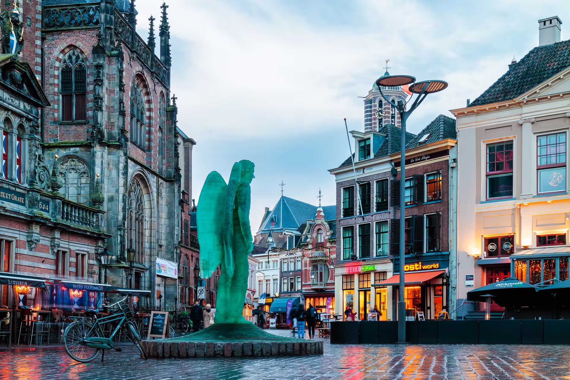 Zwolle Grote Markt with Peperbus tower and modern statue, ideal stop on 1-day audioguide walking tour